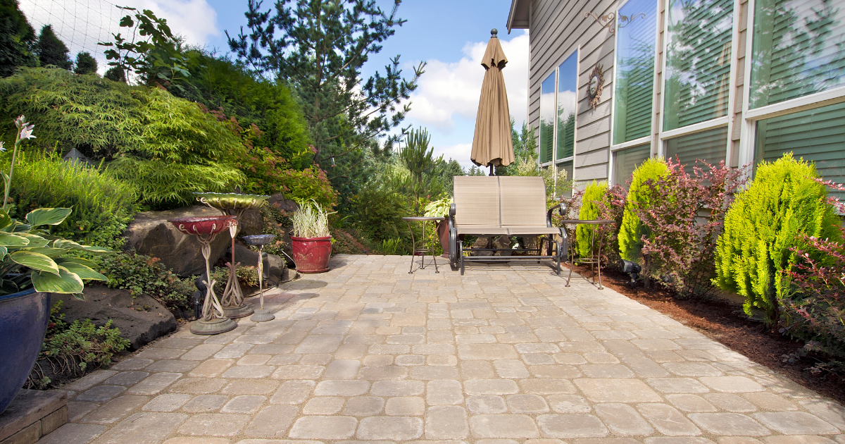 Paver patio and garden path near a home