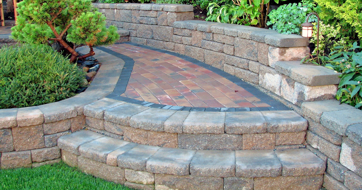 Curved paver walkway through a landscaped garden